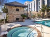 Outdoor pool and hot tub with pool lift.