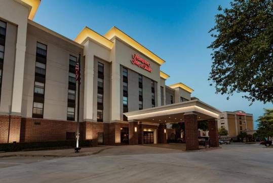 Entrance to the hotel with the hotel sign.