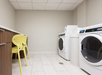 Guest laundry with two washing machine and folding area.