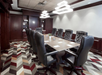 Conference room with black leather executive chairs.