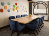 Meeting facility with a long table and executive chairs.