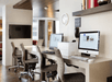 Business center with two computers, a printer and a flat-screen TV.