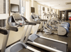 Fitness room with treadmills, and other cardio equipment and weights.