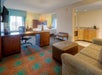 Spacious King room with sofa/seating area, a work desk and chair.