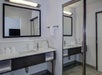Fresh towels and free toiletries inside a guest bathroom.