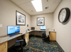 Business center with two computers and a printer.