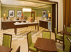 Breakfast dining area with assorted fresh fruits, juices, breads and pastries, waffle maker and tables and chairs.