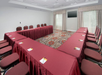 Meeting facility with U-type setup and a flat-screen TV.