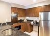 In-room kitchen with refrigerator, coffee maker, stove top, and microwave.