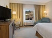 One king bed and flat-screen TV inside a guest room.