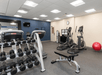 Fitness facility with cardio equipment and free weights.