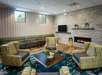 Lobby with seating area, fireplace and TV.
