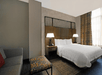 One king bed and a sofa bed inside a guest room.