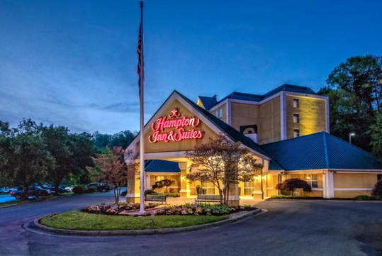 The hotel exterior glowing beautifully at night, welcoming you with warmth.