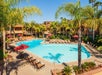 Outdoor pool with lounge chairs and umbrellas.