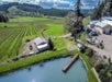 Sweeping aerial views of lush vineyards and estate grounds.