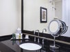 Private bathroom with vanity area.