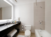 Private bathroom with bathtub and a well-lighted vanity area.