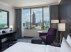 A cozy guest room with one king bed, a comfortable chair, and a work desk for all your relaxation and productivity needs.