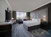 A well-appointed guest room featuring one king bed, a work desk, and a flat-screen TV for a comfortable and productive stay.