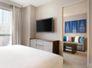 One king bed, flat-screen TV, separate living area, and a sofa bed.