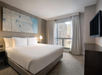 One king bed and a flat-screen TV inside a guest room.