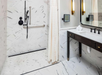 Private bathroom with vanity area, walk-in/roll-in shower, and fresh towels