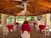 Outdoor events area with round tables and chairs setup.