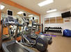 Fitness center with tread mills, yoga gym ball, and weights.