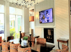 Lobby area with TV and fireplace at Hilton Garden Inn Cincinnati Blue Ash, OH.