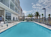 Outdoor pool with sun loungers.