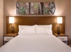 One king bed with plush bedding inside a guest room.