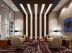 Beautifully decorated common area with a sofas, comfortable chairs, flat-screen TV and carpeted floors.