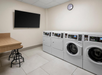 Guest laundry area with dryers and washers.