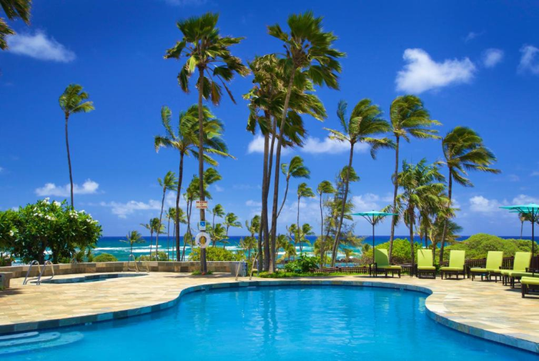 Outdoor pool with sun loungers.