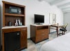 Mini fridge, microwave and flat-screen TV inside a guest room.