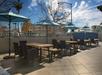 Enjoy outdoor seating and relaxation under the shade of umbrellas.