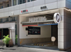Parking garage entrance with signs for exit, entry, and clearance height of 8 feet 2 inches.