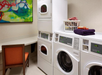 Guest laundry with seating area.