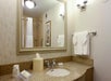 Private bathroom with fresh towels, bath amenities, and a vanity area.