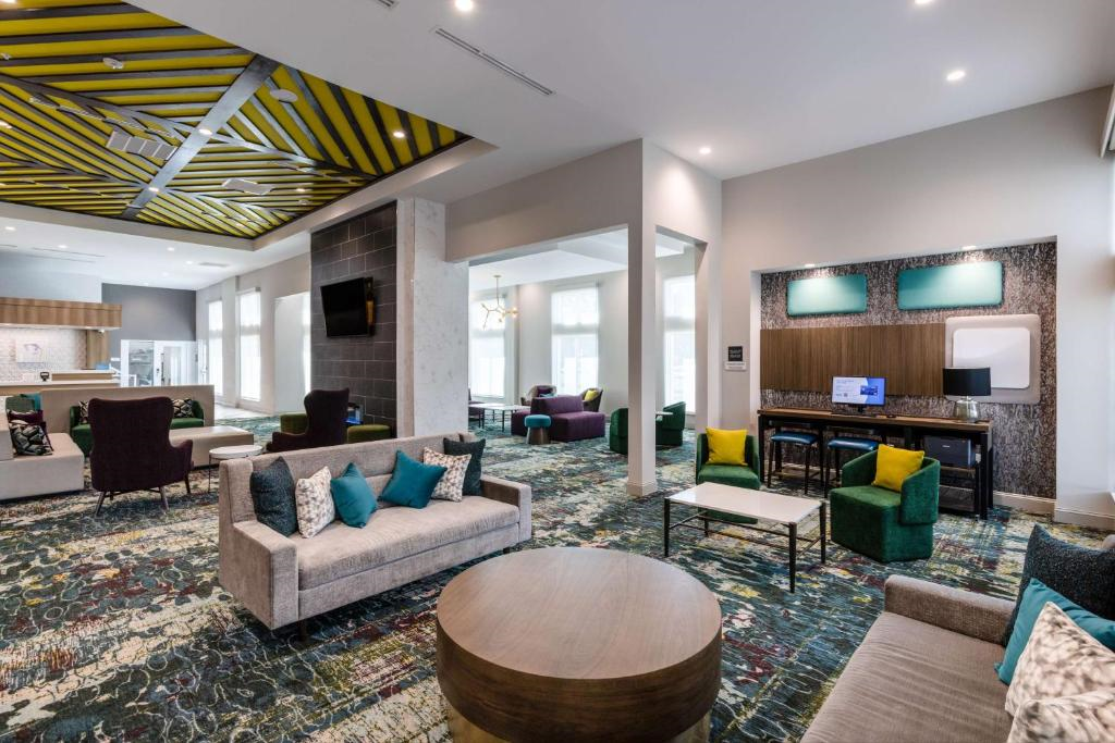 The hotel lobby welcomes guests with comfortable seating and a warm atmosphere.