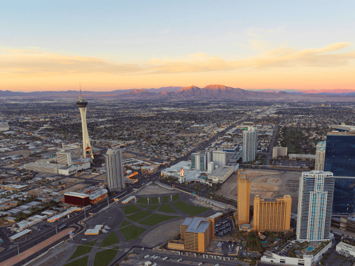 View looking out over Las Vegas from Hilton Grand Vacations Club on the Las Vegas Strip with the mountains and sunset in the distance.