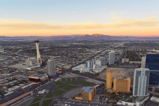View looking out over Las Vegas from Hilton Grand Vacations Club on the Las Vegas Strip with the mountains and sunset in the distance.