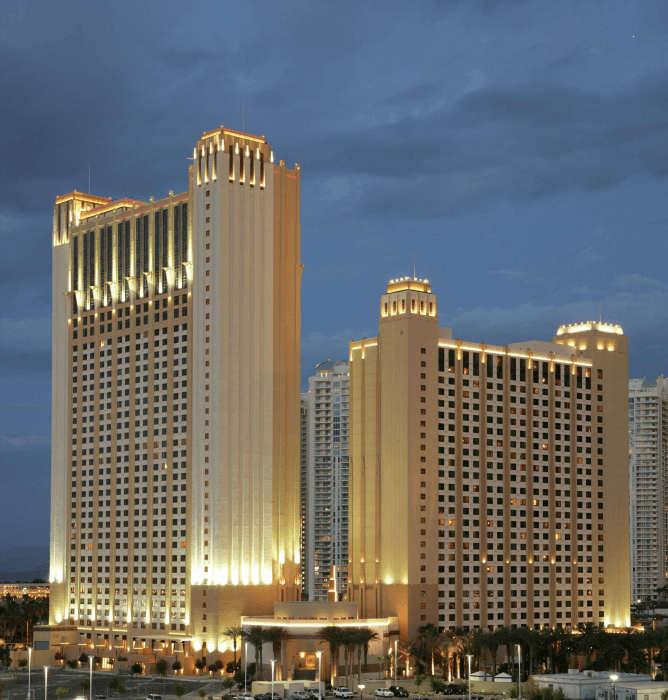 View looking up a the Hilton Grand Vacations Club on the Las Vegas Strip at dusk on a cloudy day.
