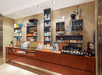 A market area in the spa with brown cabinets with several different skin care and other beauty items displayed on top.