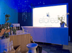 A spay room with soft blue light, a white table, a shelf with products on it, and a glowing sign that says "eforea SPA AT HILTON".