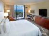 One king bed and a flat-screen TV inside a guest room.