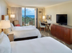Two double beds inside a guest room.