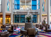 Stylish lobby with seating area and a chandelier.
