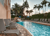 Outdoor pool with sun loungers at Hilton Naples, FL.